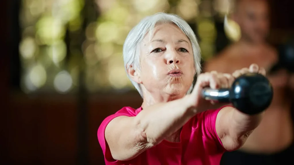 Toning Bingo Wings: Effective Exercises and Tips for Achieving Sleeker Arms 2 Person performing arm exercises with dumbbells Guildford