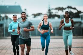 Sculpting Sleek Arms: The Essential Role of Cardio in Toning Without Bulking Up 3 image of people running to incorporate cardio Guildford exercise into their life to help tone arms and body.